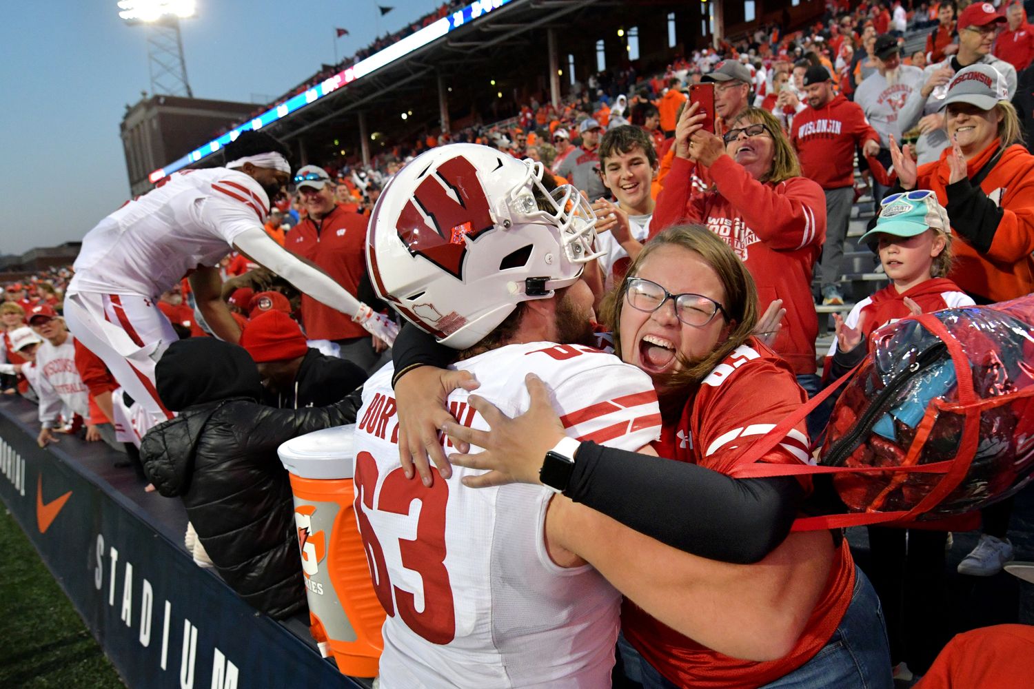 Oct 21, 2023; Champaign, Illinois, USA; Wisconsin Badgers offensive lineman Tanor Bortolini (63) gets a hug from a fan after a game against the Illinois Fighting Illini at Memorial Stadium. Mandatory Credit: Ron Johnson-USA TODAY Sports